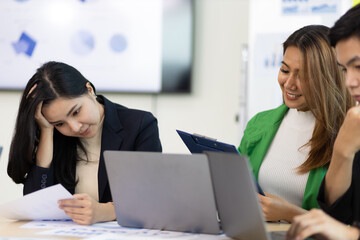 Group of business colleagues who are serious about working in the organization during a staff meeting to discuss work planning before the deadline.