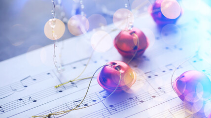 Fototapeta na wymiar Christmas carol with jingle bells and candles