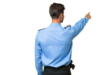 Young police man over isolated background pointing back with the index finger