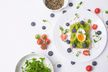 Bread with avocado , vegetables fruit and egg on white background , Healthy breakfast concept