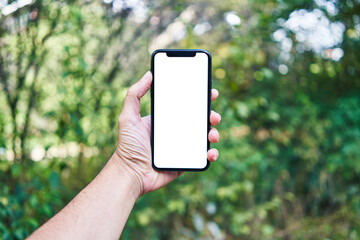 Man holding smartphone showing white blank screen at park