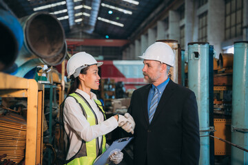 Portrait of Professional Engineers express a high level of confidence and shake hand at the railway garage.