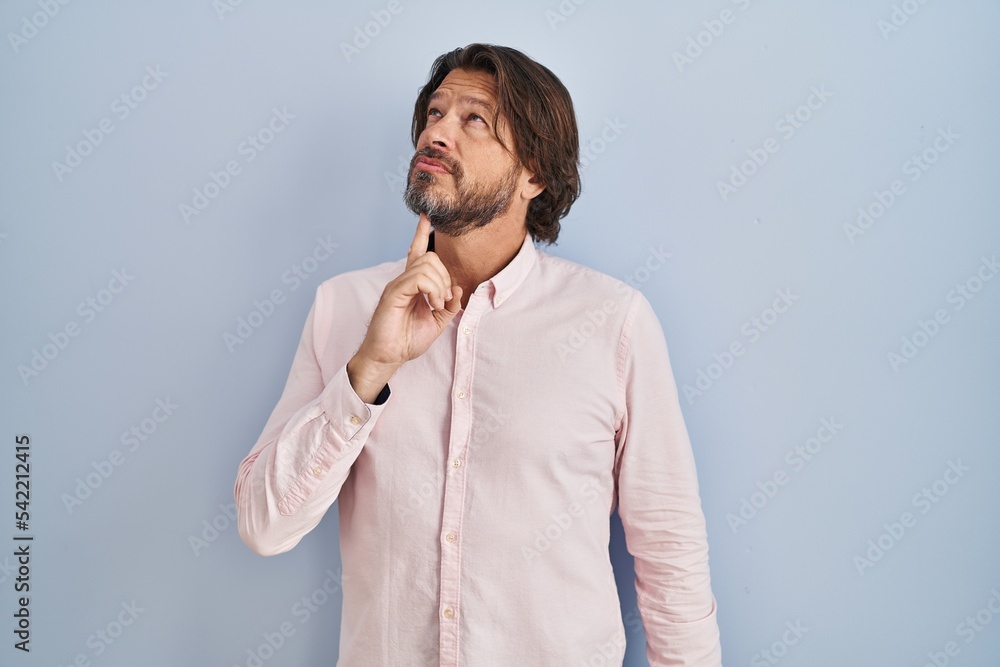 Canvas Prints Handsome middle age man wearing elegant shirt background thinking concentrated about doubt with finger on chin and looking up wondering