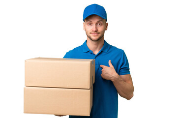 Delivery caucasian man over isolated background with surprise facial expression