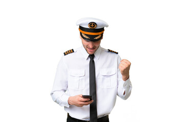 Airplane pilot man over isolated background surprised and sending a message