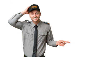 Young security caucasian man over isolated background surprised and pointing finger to the side