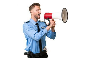 Young police man over isolated background shouting through a megaphone
