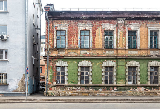 Old merchant's house with dilapidated walls with peeling paint