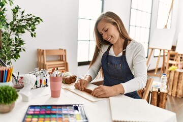 Young caucasian woman smiling confident make handmade clay pot at art studio