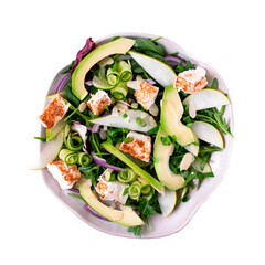 Isolated salad with avocado, pear, cucumber, soft cheese and arugula served on the ceramic plate on white background. Top view