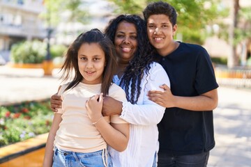 African american family hugging each other at park