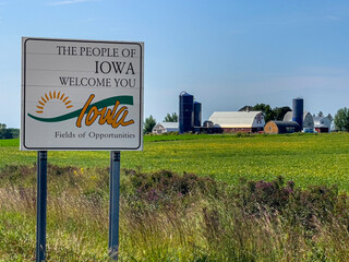 Welcome Sign for Iowa in front of a local Farm