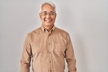 Hispanic senior man wearing glasses with a happy and cool smile on face. lucky person.