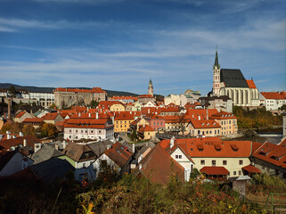 Picturesque autumn cityscape of Cesky Krumlov overlooking its historic centre and ancient Castle on bank of Vltava river, Czech Republic