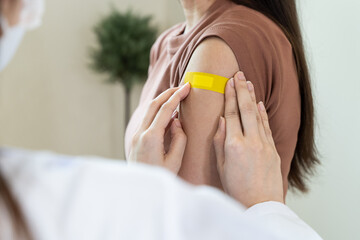 person confident after getting vaccine by  showing sign thumb up.