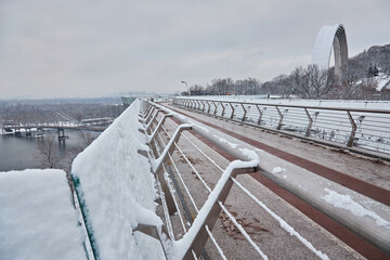 Pedestrian bridge in Kiev in snowy weather.