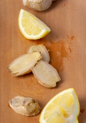 Lemon and ginger slices on cutting board. Top view. Close up.