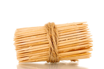 Wooden toothpicks tied with jute rope, macro, isolated on white background.