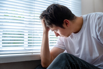 Sad Man near the Window