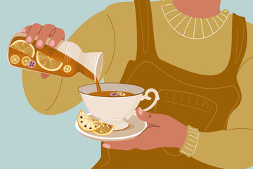Woman holding a decanter of tea with lemon and orange slices. Winter and autumn cozy concept with a hot cup of warm drink.  Aromatic warming drink with fruits. 