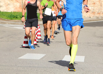 Fototapeta na wymiar athletic runner with long muscular legs during the foot race