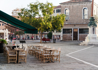 cat on top of a restaurant table in Venice, Italy 