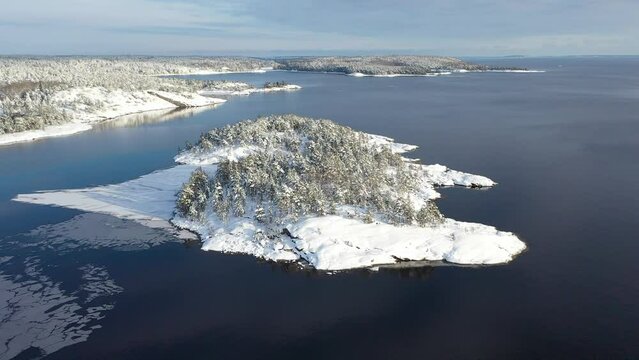 National Park Ladoga Skerries, in winter in Karelia Russia Small stone islands in the snow on Lake Ladoga on a sunny day
