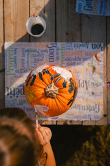 Top view of a pumpkin painted by a child for a Halloween party