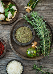 Fresh and dried rosemary with rosemary oil on the wooden table
