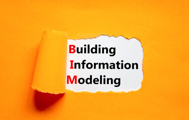 BIM building information modeling symbol. Concept words BIM building information modeling on white paper on beautiful orange background. Business BIM building information modeling concept. Copy space.