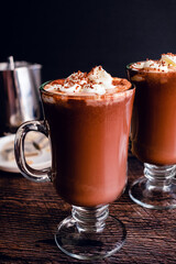 Mugs of Hot Chocolate Topped with Whipped Cream and Shaved Chocolate: Hot cocoa infused with Earl Grey tea with chantilly cream spooned on top