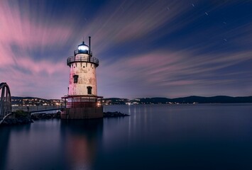 Beautiful night view of the Tarrytown Lighthouse in Sleepy Hollow, NY, with long exposure clouds