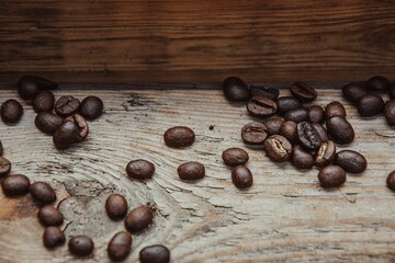 Closeup of coffee beans on a wooden surface - perfect for backgrounds