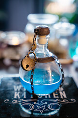 A magical blue elixir closed with a secret padlock. Magical alchemical potion bottle made by a...