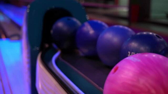 Close-up of hand takes the bowling ball, fingers get into holes