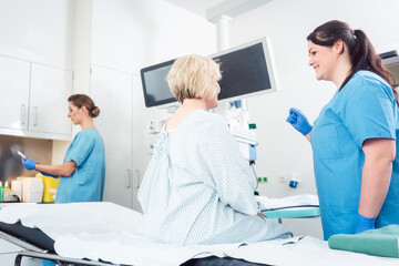 Nurse explaining procedure to patient in hospital surgery to ease anxiety