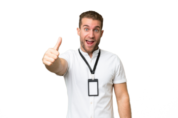 Young caucasian man with ID card isolated on green chroma background with thumbs up because something good has happened