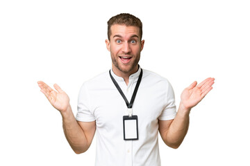 Young caucasian man with ID card isolated on green chroma background with shocked facial expression