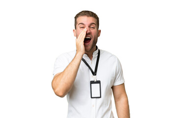 Young caucasian man with ID card isolated on green chroma background shouting with mouth wide open