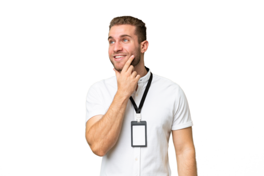 Young caucasian man with ID card isolated on green chroma background thinking an idea while looking up