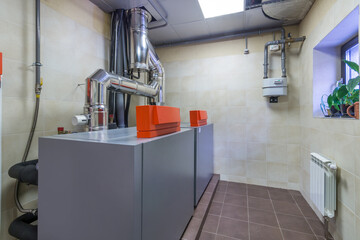 Modern gas boiler room with equipment for an autonomous heating system.