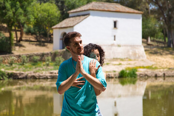 beautiful woman and handsome man latinos dancing bachata are dancing by the river in the forest....