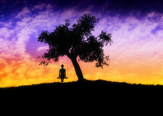 Girl on swing under tree at sunset