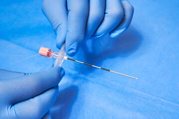 Epidural Anesthesia. Needle for anesthesia in the hands of a medic in protective gloves
