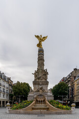 Fototapeta na wymiar view of the Sube Fountain statue with the golden angel in downtown Reims