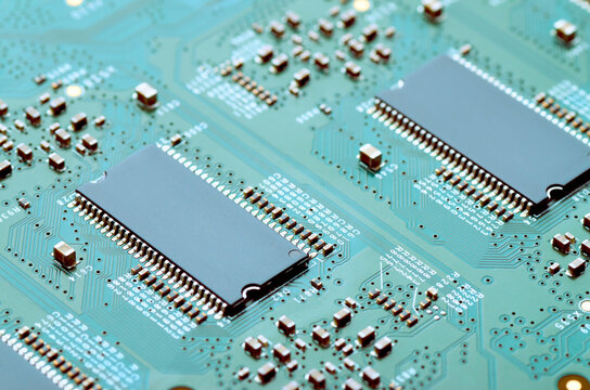 Modern electronic board with microchips and electronic parts close-up, soft focus