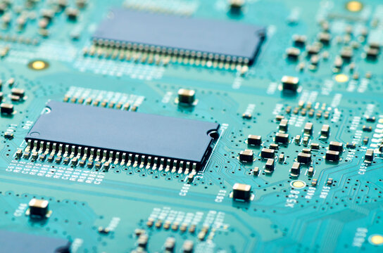 electronic board with microchips and electronic parts close-up, soft focus