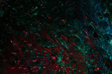 Space abstraction. Turquoise spheres are illuminated by flashes of malachite-red lights and are located against a dark background. 3D render.