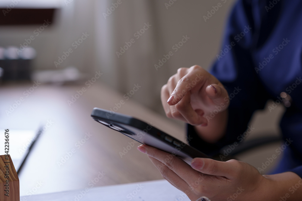 Poster close-up of a woman using a smartphone to do business with customers via messaging app line, conduct