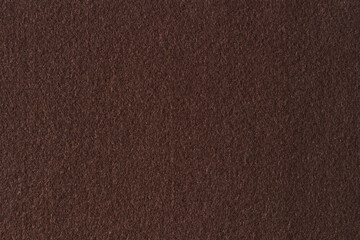Brown color felt textile fabric material texture background. Abstract monochrome dark brown color...